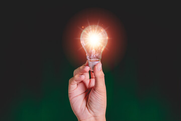 Man's hand holding a light bulb, creativity. Ideas, new ideas, solving problems and improving things.