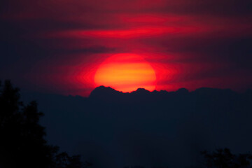 Fiery Sunset Over Silhouetted Mountains