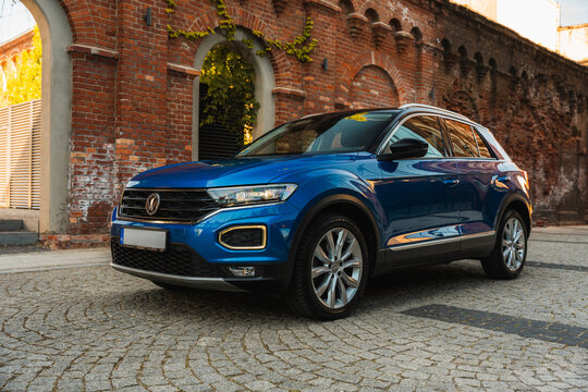 Photo of a blue Volkswagen T-Roc. They show details of the car. Rims, emblems, headlights, lamps and interior, dashboard. The photo is suitable for use in marketing materials, advertisement