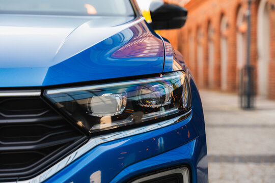 Photo of a blue Volkswagen T-Roc. They show details of the car. Rims, emblems, headlights, lamps and interior, dashboard. The photo is suitable for use in marketing materials, advertisement