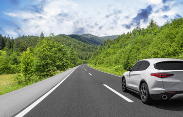 A car rushes along a forest road.