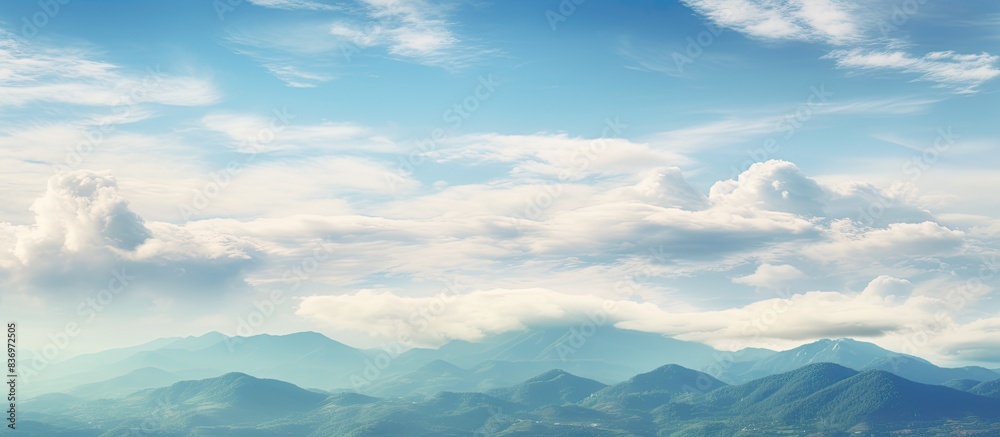 Poster vibrant clouds fill the sky above the mountain in the afternoon, creating a picturesque scene with a