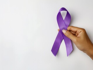 Person holding purple ribbon