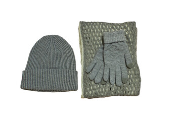 a gray knitted hat with gloves and a scarf on a white background, set of women's winter clothes, clothes on a white background