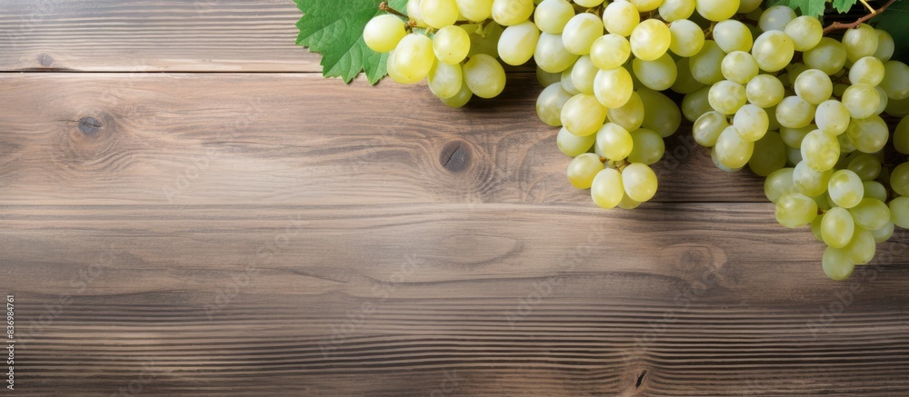 Poster White table grapes on a rustic wooden background with copy space image.