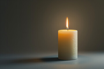 a white wax candle burning softly against a gray background