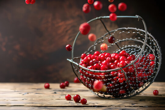 redberries in a basket on a wooden table