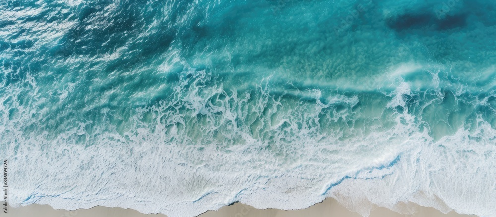 Poster coast with waves as a background from top view blue water background from drone summer seascape from