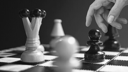 Strategic thinking concept is shown with the Hand moving chess figure in competition success play....