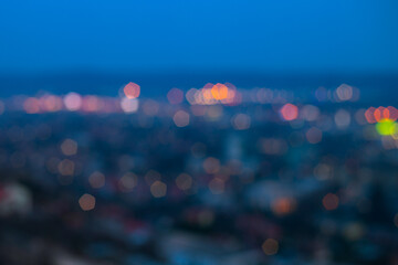 Defocused photo of big city  during beautiful blue hour with city and street lights glowing colorfully.