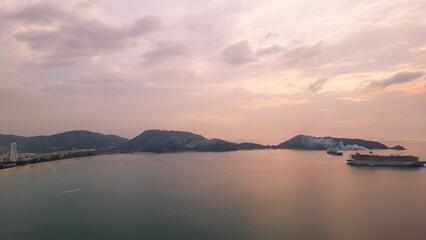 Aerial view, drone flying over Phuket city, Thailand. Drone over Patong Beach on Sunday in Phuket and tourists shopping at a street full of local merchants selling food, people resting by the sea.