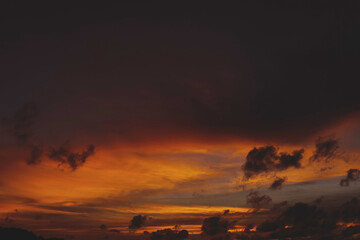 Sunset over the water with clouds against the sunlight on the Andaman Sea, Patong, Phuket, Thailand.