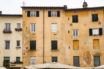 Building facade in Piazza dell Anfiteatro the heart of the city of Lucca, Italy