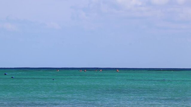 Red canoes on the sea panorama Playa del Carmen Mexico.