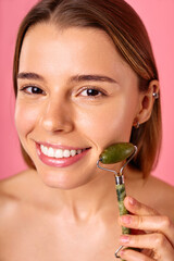 A woman using Jade Roller for skincare to promote healthy glowing skin naturally