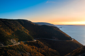 Fototapeta premium Scenic view of the coastilne with the sea and mountains from the Skyline trail, at the Cape Breton Highlands National Park, in Nova Scotia, Canada, at sunset.