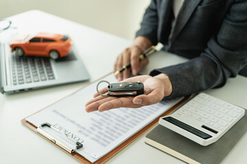 Car sales representative or sales manager with customer having approved financial loan with bank,...