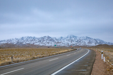 Haixi Mongolian and Tibetan Autonomous Prefecture, Qinghai Province - grasslands and roads under the snow-capped mountains