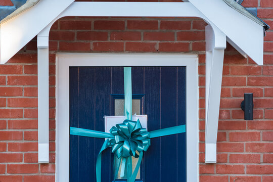 Door of sold new built property with congradulation ribbon in england uk