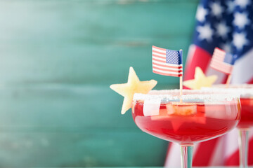 4th of July Holiday background. Cranberry punch with ice and stars shaped apple pieces in glass...