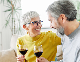 love senior woman couple home wine glass celebration toast wineglass alcohol cheers holiday beverage red romantic anniversary dating toasting valentine eve portrait happy husband wife