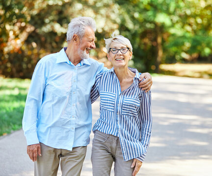 woman man senior couple happy retirement together elderly active vitality park fun smiling love old nature wife happiness mature walking holding hands