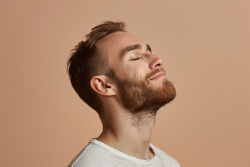 Fototapeta premium A close up of a man with beard and closed eyes looking to a side