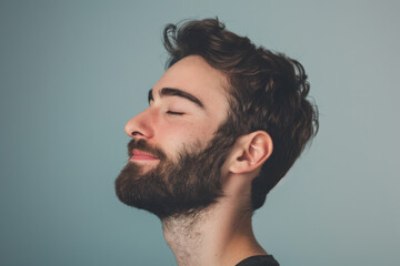 Fototapeta premium A close up of a man with beard and closed eyes looking to a side