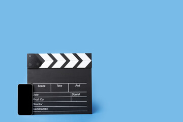 Cinema tickets online, clapper board and phone, accessing the movie booking service through the...