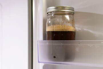 Cold brew coffee in a mason jar in the fridge.