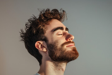 Fototapeta premium A close up of a man with beard and closed eyes looking to a side