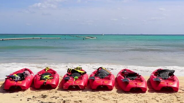 Red canoes at tropical beach panorama Playa del Carmen Mexico.