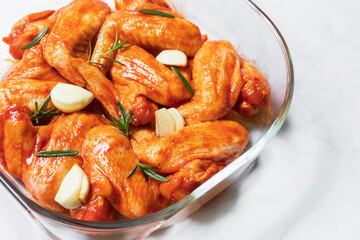 Marinated roast a spicy chicken wings with garlic and rosemary.
