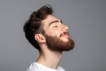 Fototapeta premium A close up of a man with beard and closed eyes looking to a side