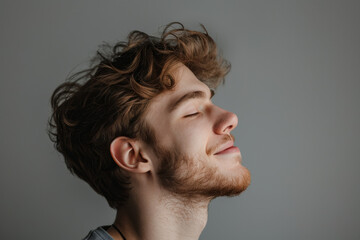 Fototapeta premium A close up of a man with beard and closed eyes looking to a side