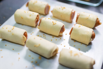 Homemade mini sausage wrapped in puff pastry prepare for bake.
