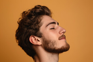 Obraz premium A close up of a man with beard and closed eyes looking to a side