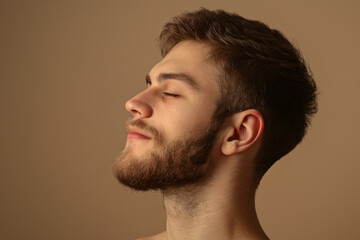 Fototapeta premium A close up of a man with beard and closed eyes looking to a side