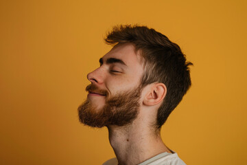 Fototapeta premium A close up of a man with beard and closed eyes looking to a side