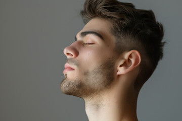 Obraz premium A close up of a man with beard and closed eyes looking to a side