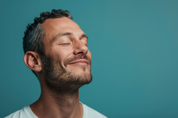 Obraz premium A close up of a man with beard and closed eyes looking to a side