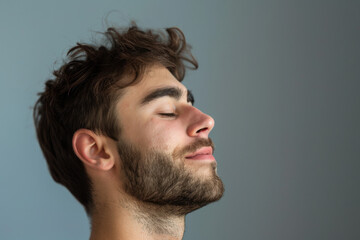 Fototapeta premium A close up of a man with beard and closed eyes looking to a side