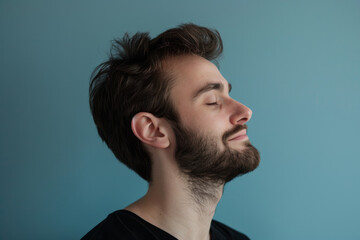 Obraz premium A close up of a man with beard and closed eyes looking to a side