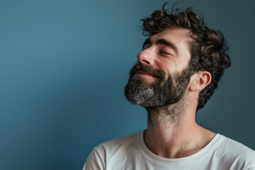 Obraz premium A close up of a man with beard and closed eyes looking to a side