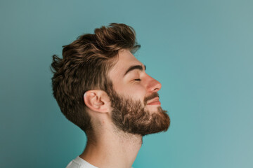 Fototapeta premium A close up of a man with beard and closed eyes looking to a side