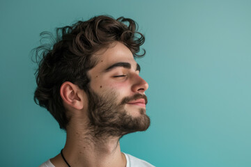 Obraz premium A close up of a man with beard and closed eyes looking to a side