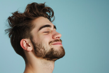 Obraz premium A close up of a man with beard and closed eyes looking to a side