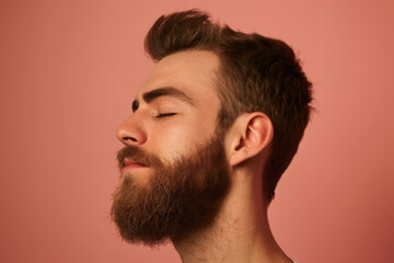 Obraz premium A close up of a man with beard and closed eyes looking to a side