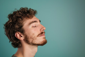 Obraz premium A close up of a man with beard and closed eyes looking to a side