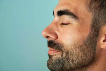 Fototapeta premium A close up of a man with beard and closed eyes looking to a side